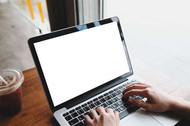 istock A blank screen for hand typing text,using laptop and mobile phone contact business searching information in workplace on desk at office. 2165452105