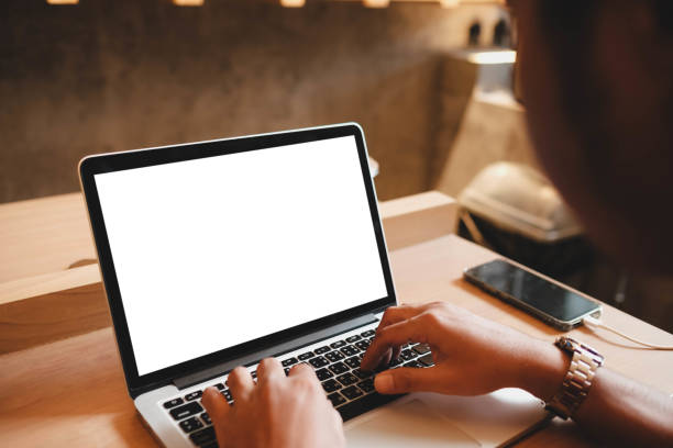 istock A white blank screen for hand typing text,using laptop computer contact business searching information in workplace on desk at cafe. 2165452181