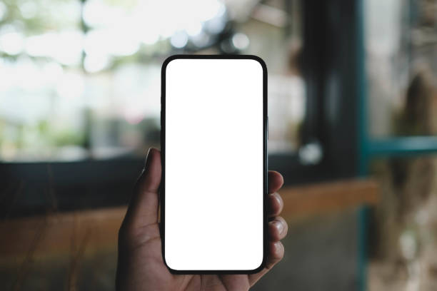 istock Close up of a man using cell  white blank screen a mobile phone and sending massages on the coffee shop. 2165452186