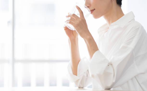 Woman drinking water at home