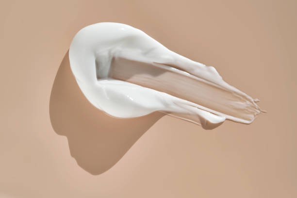 istock A smear of white cream on a beige background. 2165454919
