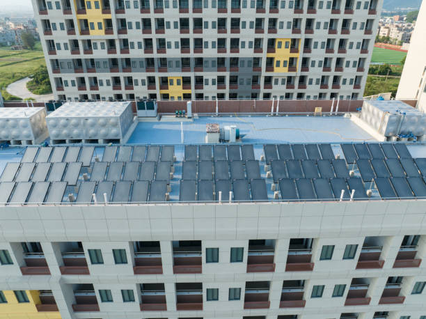 istock Solar water heater on building roof 2165458355