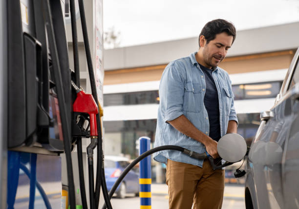 istock Man refueling his car at a gas station 2165462179