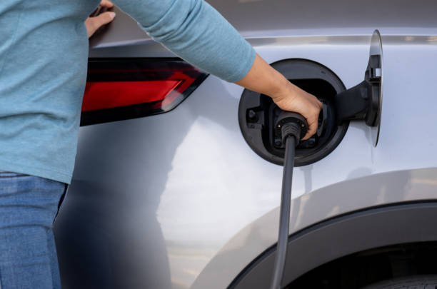 istock Woman charging a hybrid car 2165462239