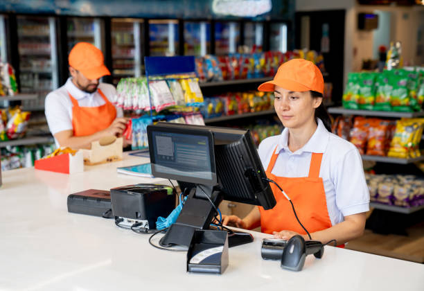 Cashier working at a convenience store at a gas station Latin American cashier working at a convenience store at a gas station gas station counter stock pictures, royalty-free photos & images