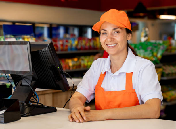 istock Retail clerk smiling while working at a convenience store 2165462309