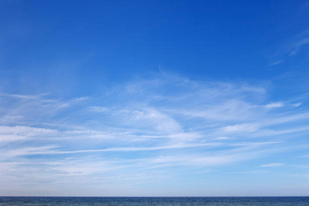 istock Beautiful blue sky over the sea with translucent, white, Cirrus clouds 2165462718