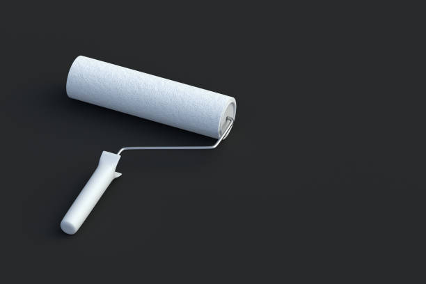 istock White paint roller on black background. Tool for renovation. Housework equipment. Professional instrument. Copy space. 3d render 2165463314