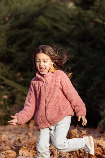 Happy Hispanic girl running and enjoying a fall day - Buenos Aires - Argentina