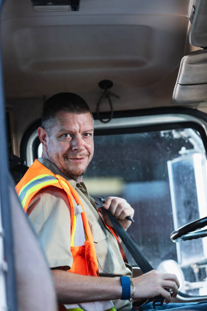 istock Truck driver buckling seat belt 2165464359