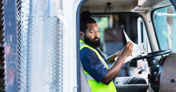 istock African-American truck driver, reading clipboard 2165464364