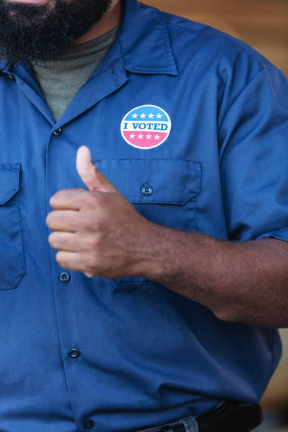 istock African-American working class man with I Voted sticker 2165464454