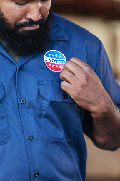 istock African-American working class man with I Voted sticker 2165464460