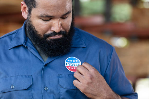 istock African-American working class man with I Voted sticker 2165464463