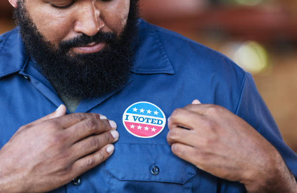 istock African-American working class man with I Voted sticker 2165464468
