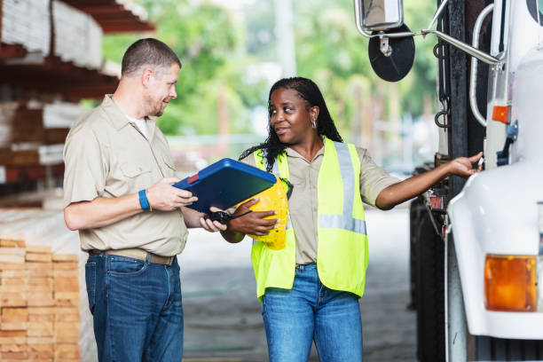 istock Workers in lumberyard with truck to deliver orders 2165464521