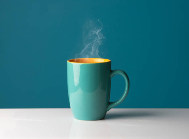 Blue hot cup of coffee with smoke on pastel blue background, copy space