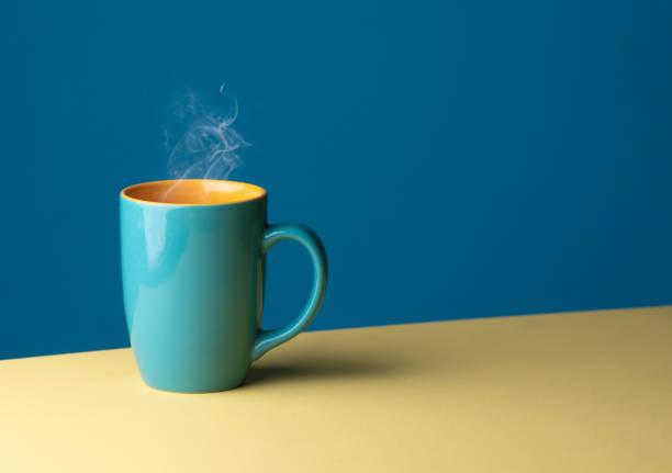 istock Blue hot cup of coffee with smoke on pastel blue background, copy space 2165465107