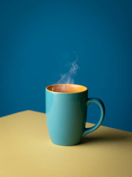 istock Blue hot cup of coffee with smoke on pastel blue background, copy space 2165465115