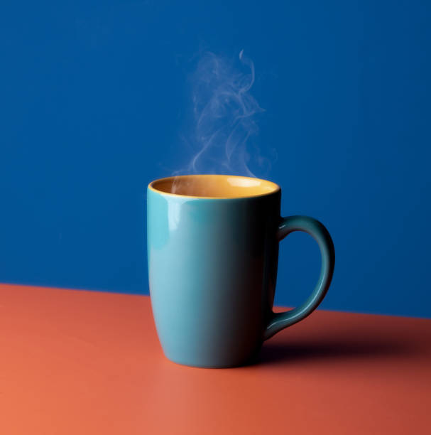 istock Blue hot cup of coffee with smoke on pastel blue background, copy space 2165465145