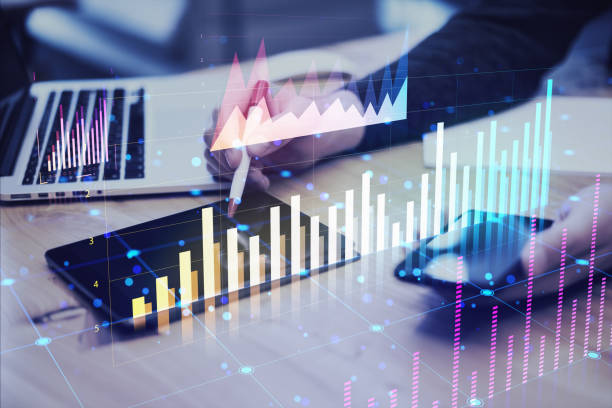 istock Person analyzing financial graphs on digital tablet and laptop in office setting. 2165471294