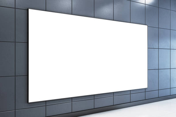 istock Large white blank poster on a dark grey tiled wall in a modern corridor. 3D Rendering 2165471361