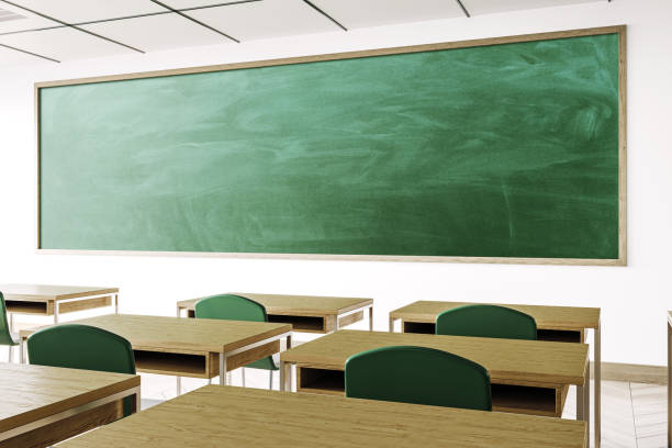 istock Modern classroom interior with large chalkboard and wooden desks. 3D Rendering 2165471493