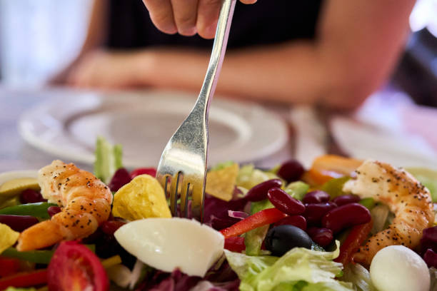 istock eating shrimp and vegetable salad 2165473718