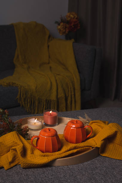 istock Fall cozy mood composition with hot drink and burning candles 2165474724