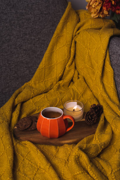 istock Fall cozy mood composition with hot drink and burning candles 2165474749