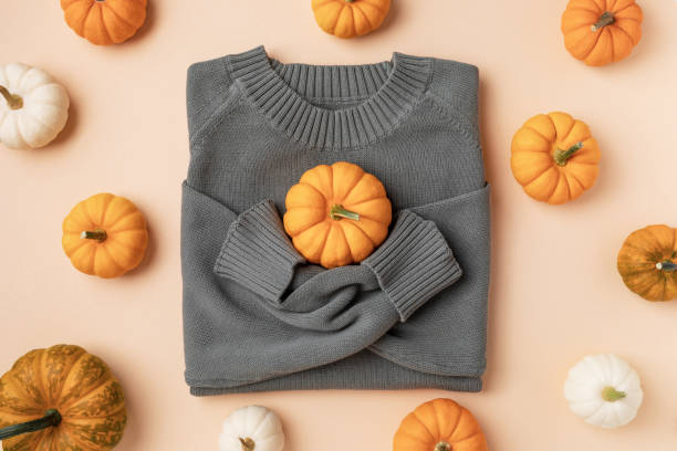 istock Autumn holiday background from knitted sweater with decorative pumpkins pattern top view. Thanksgiving, harvest, halloween, autumn and fall. 2165477969