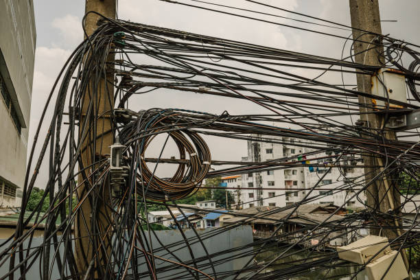 Messy electrical cables and wires on electric pole