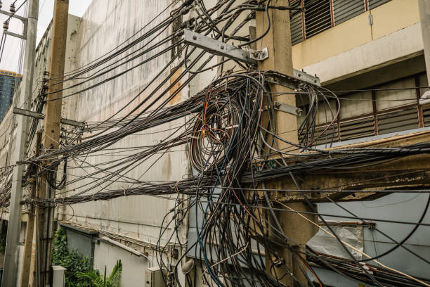 istock Messy electrical cables and wires on electric pole 2165478266