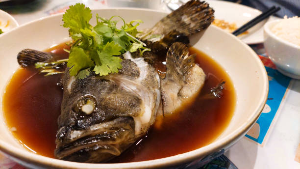 istock Chinese style steamed grouper fish served with cilantro leaves 2165478626