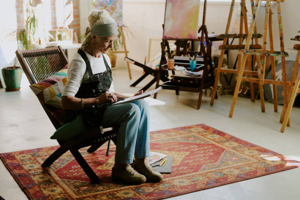 istock Senior Caucasian Woman Drawing Sketches 2165480941
