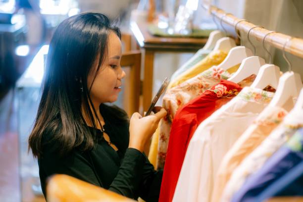 istock Young Female Browsing Traditional Peranakan Kebaya in a Store 2165481504