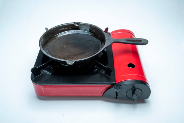 An iron small frying pan stands on a white background.