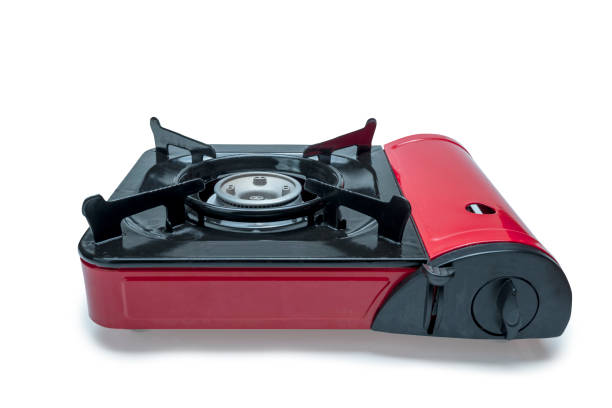 A red stove top with a black burner