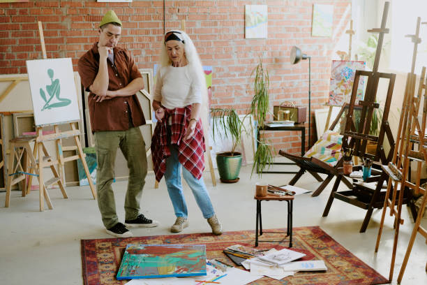 istock Two Artists Looking At Abstract Painting 2165481891