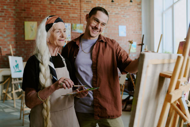 istock Art Teacher Helping Senior Woman During Class 2165481963