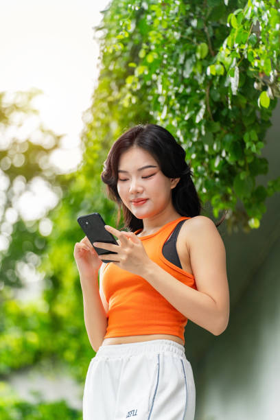 istock Young Woman Using Phone In a Park Casually 2165483133