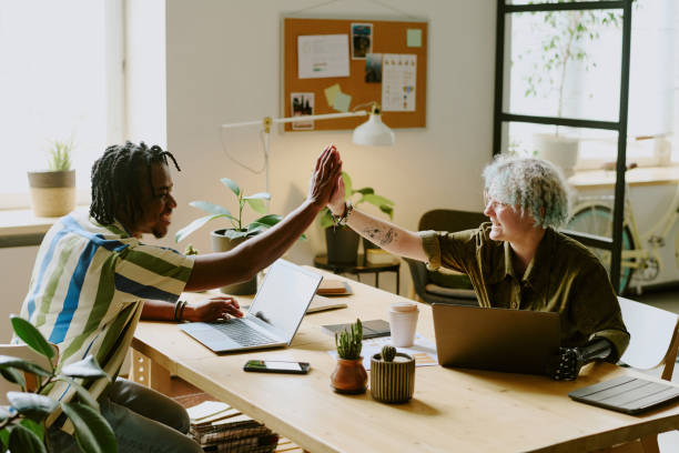 istock Cheerful Coworkers Doing High Five 2165483242