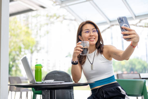 istock Digital Nomad: An Asian Woman's Remote Work Experience in a Coffee Shop 2165485515