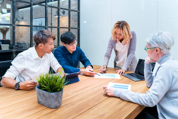 istock Team of Asian people with different age group brainstorming on data and information analysis for strategy management with young male leader for education and business concept 2165487601