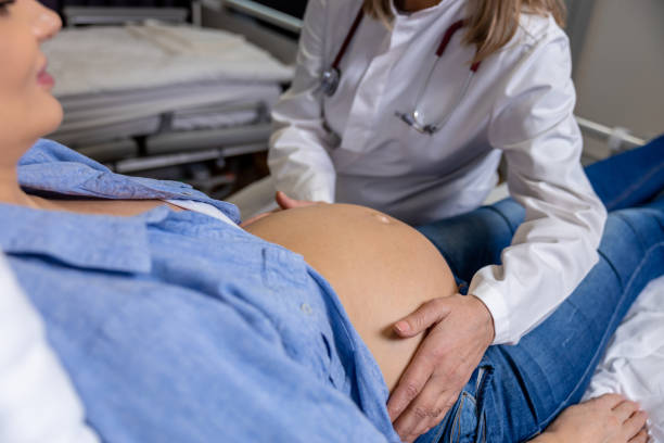 istock Doctor examining a pregnant woman on third trimester 2165487710