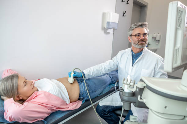 istock Male doctor looking focused while making diagnostics to a female patient 2165487900