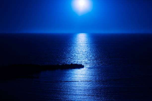istock Moon rising over the blue ocean 2165488191