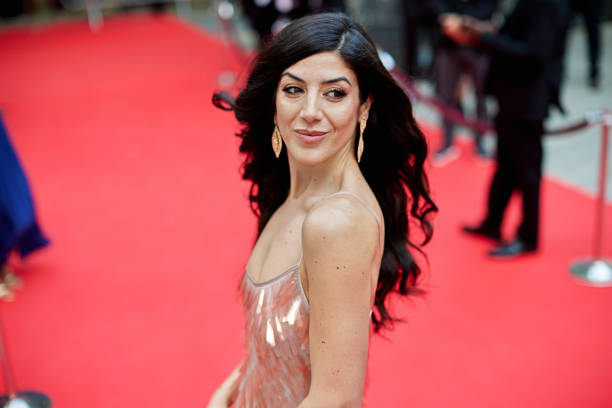 istock Longhaired brunette looking over shoulder on red carpet 2165493141