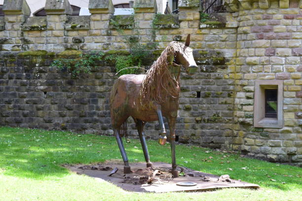 Forbach, France - 06/28/2024: An iron horse in a mining area at medieval walls