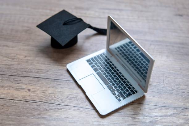 istock A graduation cap and a laptop. 2165494275